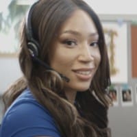 Woman in Blue Shirt Wearing a Headset