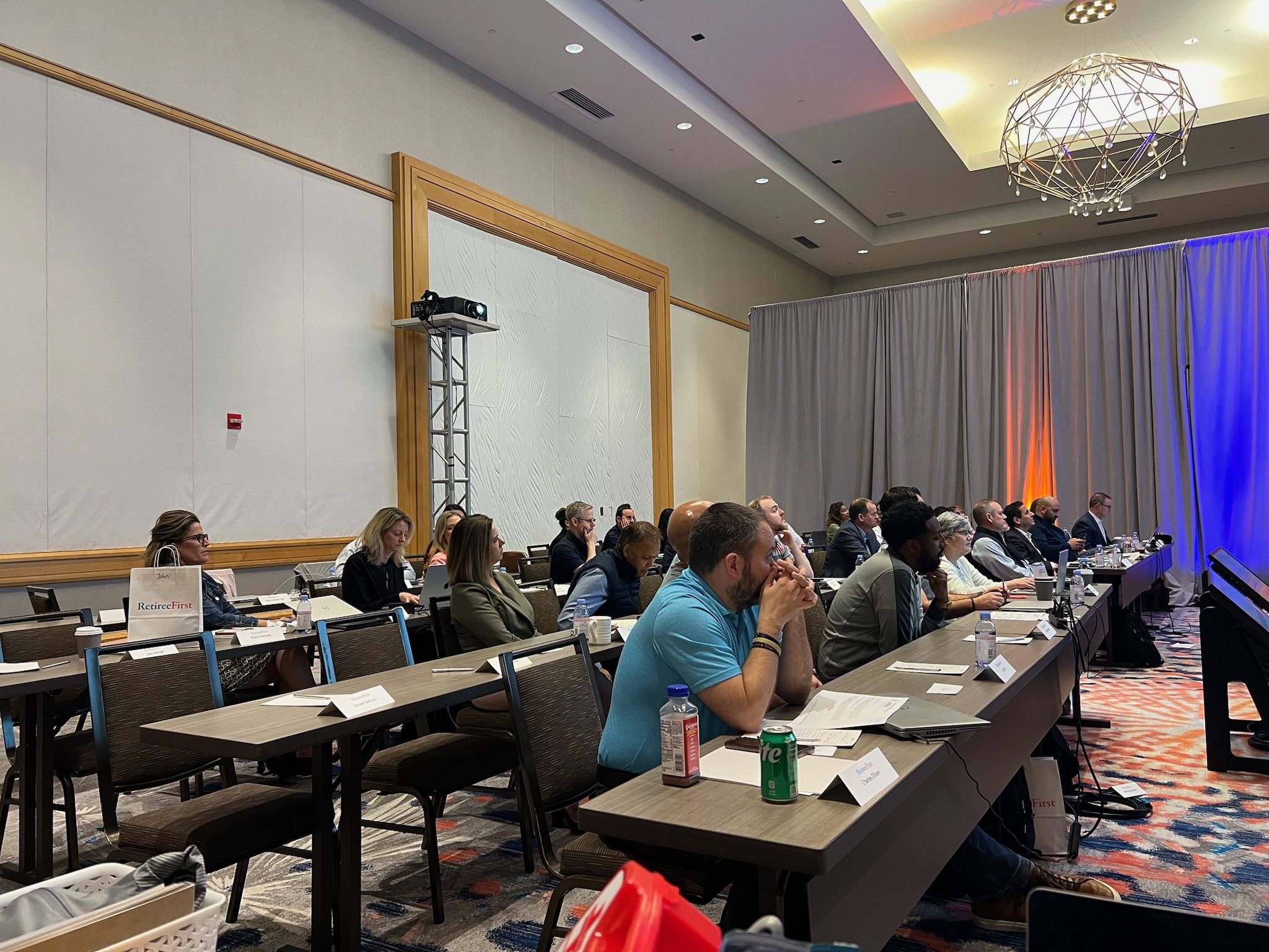 people sitting at conference tables at Retiree First growth summit