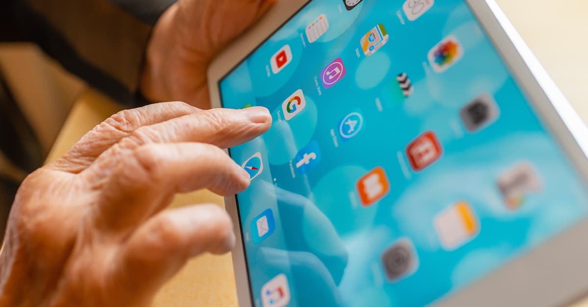persons hand tapping on a tablet