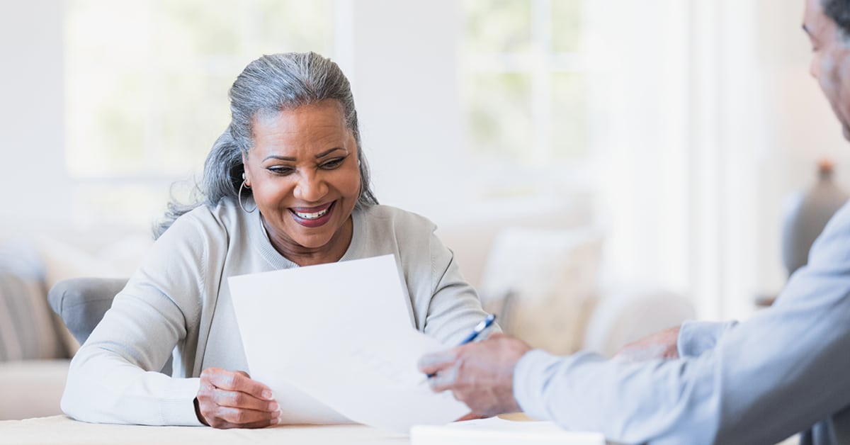 woman smiling looking at a document