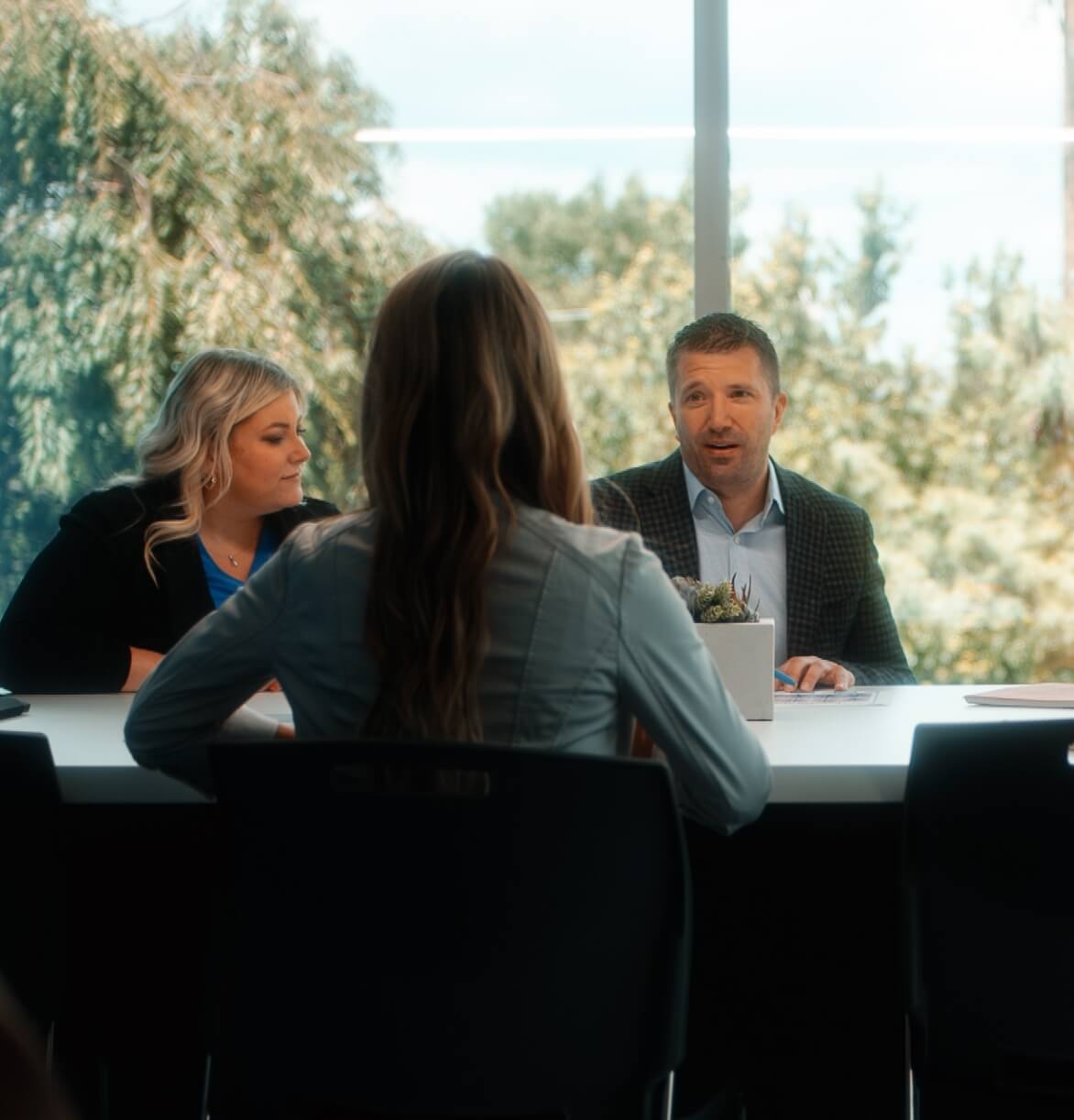people talking at a conference table together