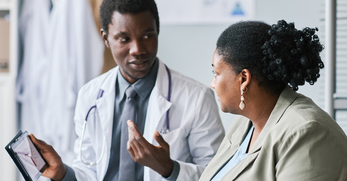 doctor talking to a patient using a tablet